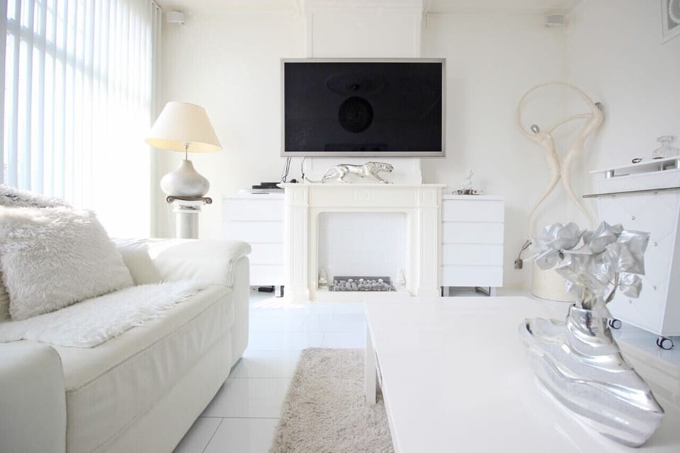 Living room with flat screen TV. 5 flat screen TVs in the penthouse