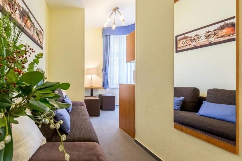 Standard Triple Room | Living area | 80-cm Smart TV with satellite channels, TV