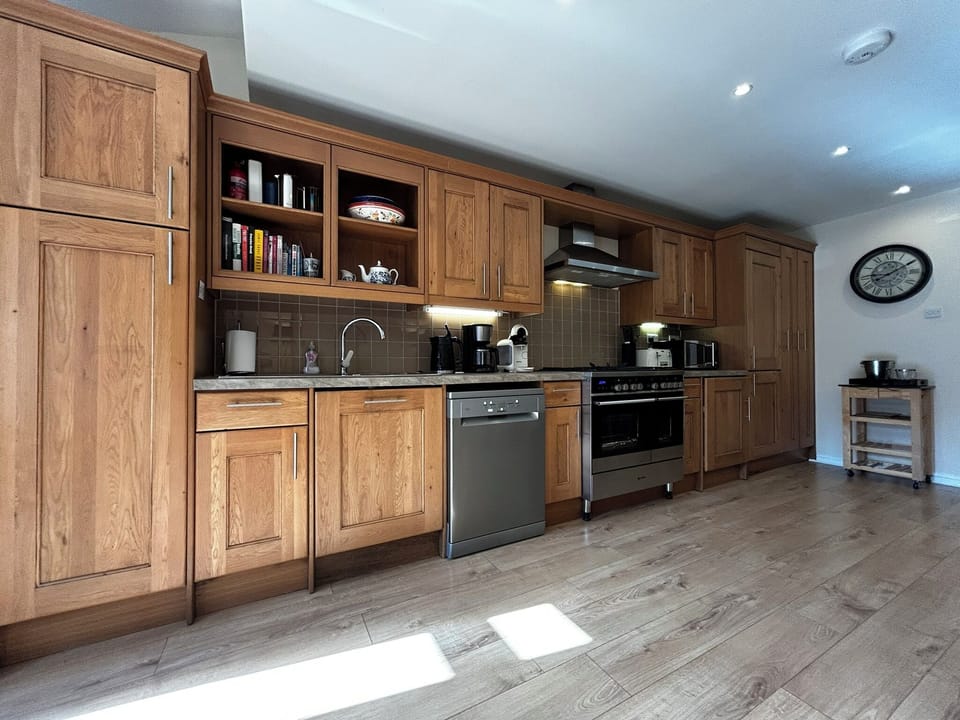 Kitchen with dishwasher, washer, dryer, fridge/freezer, microwave, oven/stove