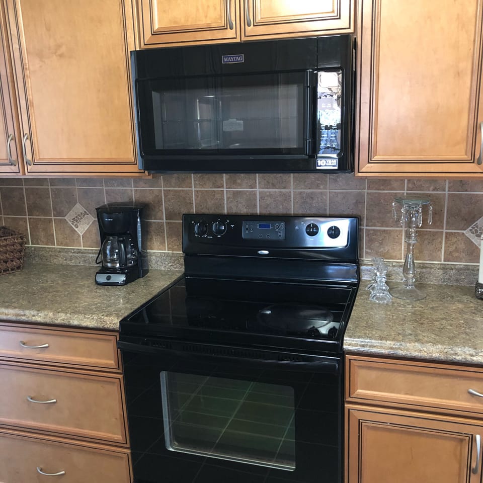 Microwave, oven and traditional coffee maker in the kitchen 