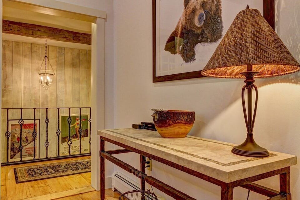 - Charming hallway decor with rustic lamp and bear artwork   - Warm lighting and wood accents create inviting mountain feel   - Cozy lodge touches enhancing your cabin-style experience