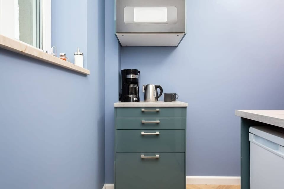 A kitchen complete with modern appliances, cookware, and utensils, making meal preparation effortless.