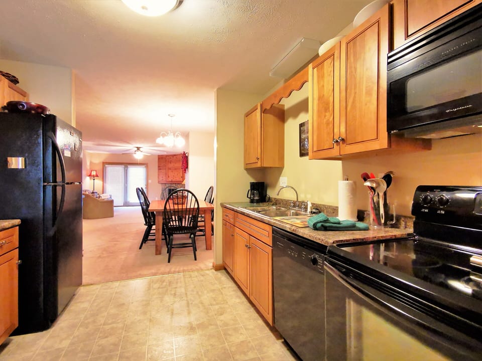 Open kitchen with wooden cabinets and modern appliances