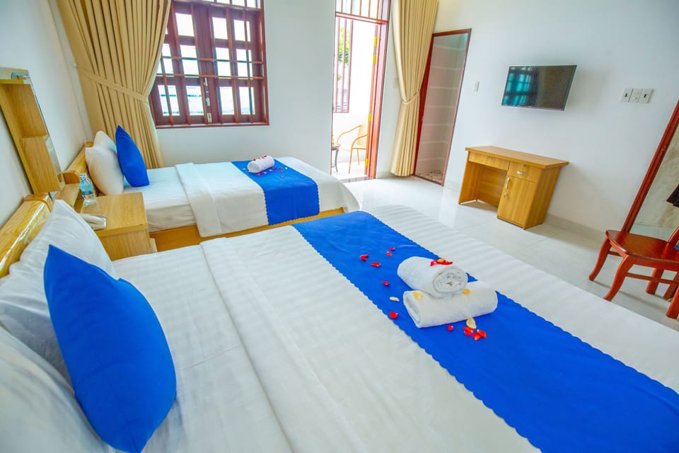 Deluxe Triple Room, City View | Minibar, in-room safe, desk, laptop workspace