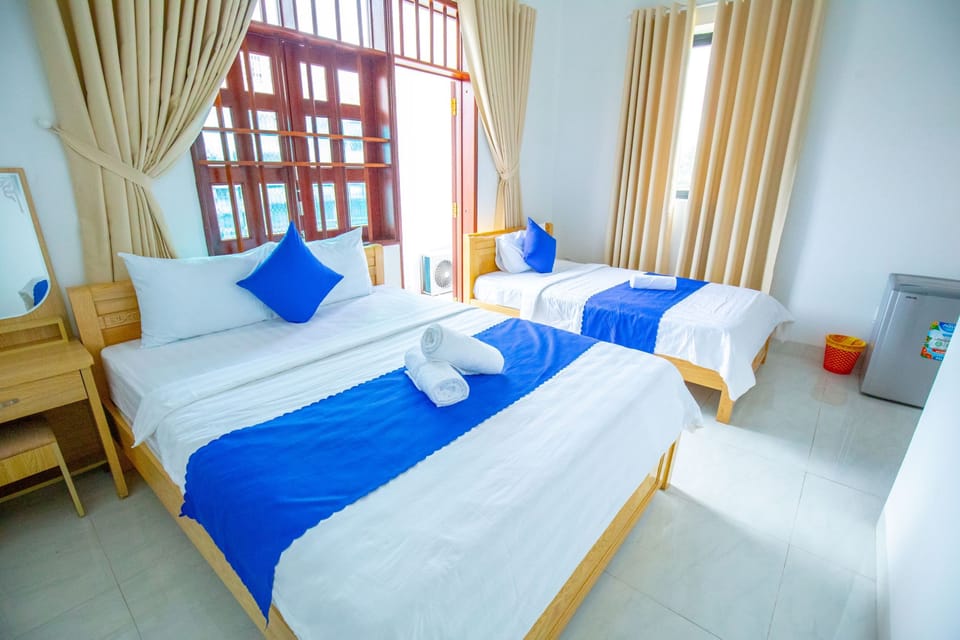 Deluxe Triple Room, City View | Minibar, in-room safe, desk, laptop workspace