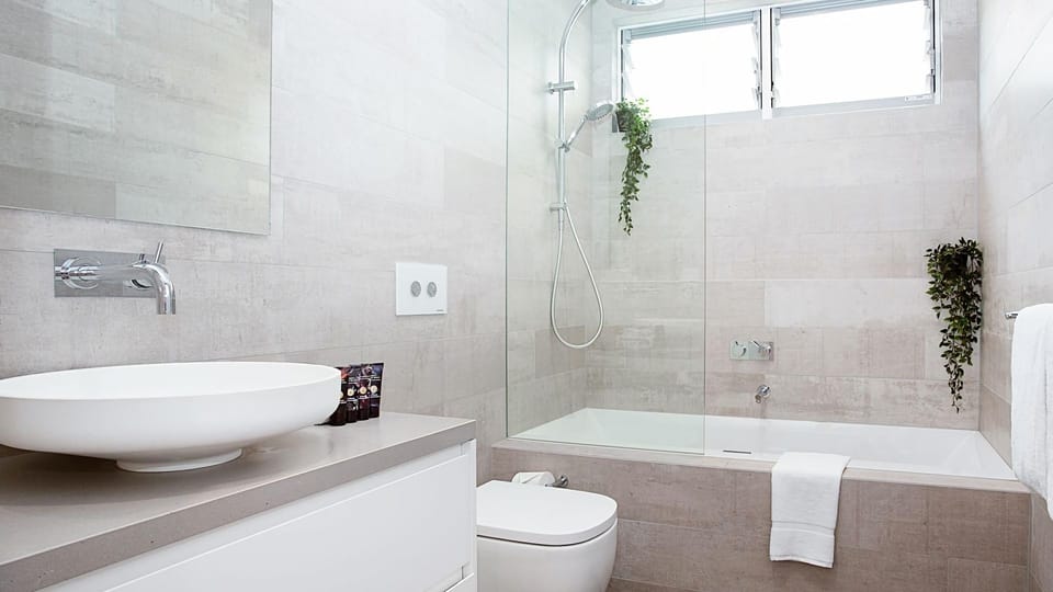 Luxurious bathtub and double shower in one of the modern bathrooms