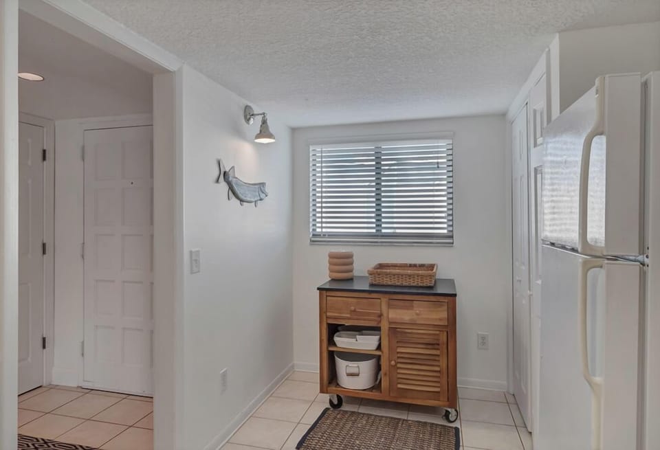 - Bright kitchen nook features a movable island, window light, and storage space
- Coastal decor and thoughtful extras give it a homey and breezy feel
- Perfect for setting up a snack bar, breakfast counter, or coffee station