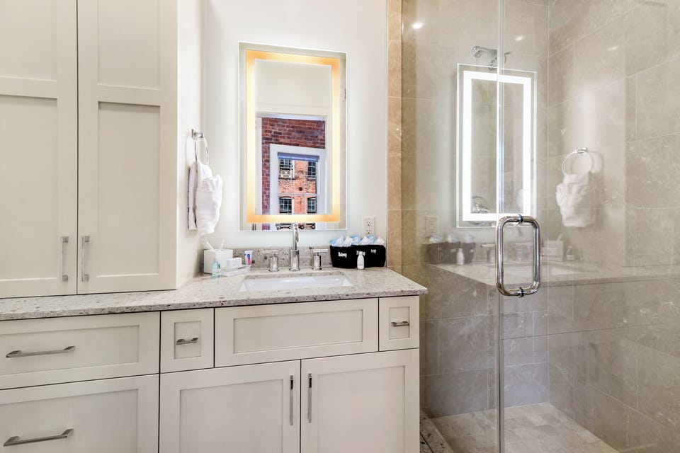 Ensuite Master Bathroom featuring large frameless glass Italian marble shower. Enjoy plush towels, blow dryer and complimentary travel size shampoo, conditioner, body wash, tooth brushes (2), tooth paste, mouth wash, lotion and makeup remover wipes.