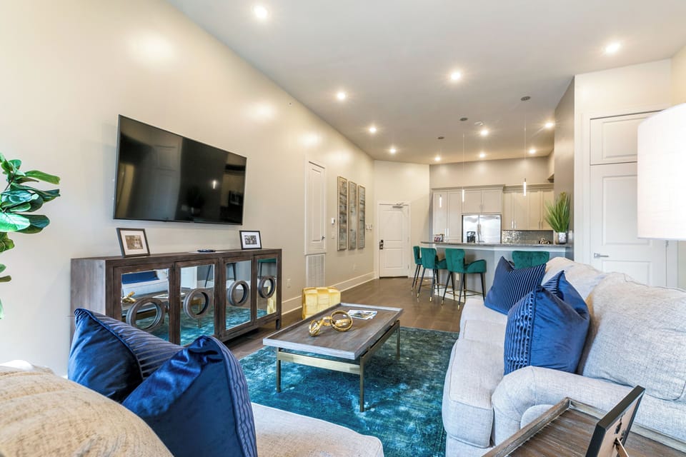 Open concept living, kitchen, and dining area with comfortable seating options for you and your guests. 65” Samsung Smart 4K TV for streaming apps and DIRECTV Entertainment. Pub-style dining table with seating for three. All the natural light too!