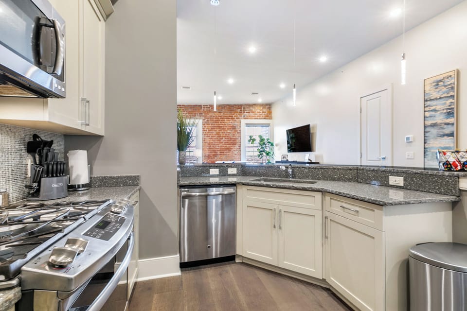 Cook and dine easily in the fully stocked kitchen, equipped with all stainless steel appliances, gas range, basic cookware, and a dining area for a comfortable meal at home. Entertain at the bar with seating for five.