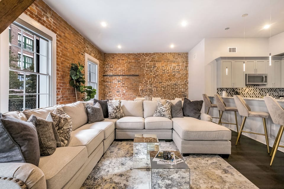 Open concept living, kitchen, and dining area with ample seating. Stream on 65” Samsung Smart 4K TV with DIRECTV. Relax on the large sectional and dine at a table for six with bar seating for four and plenty of natural light.
