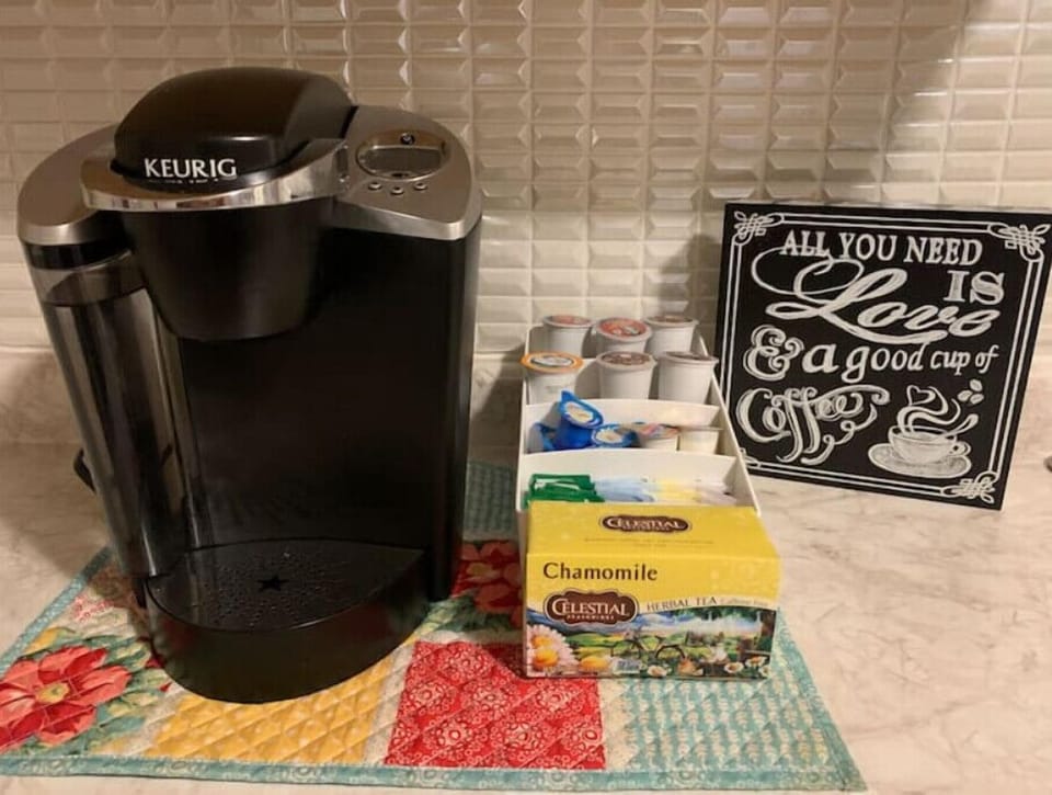 Keurig with coffee, creamer and sweetener provided
