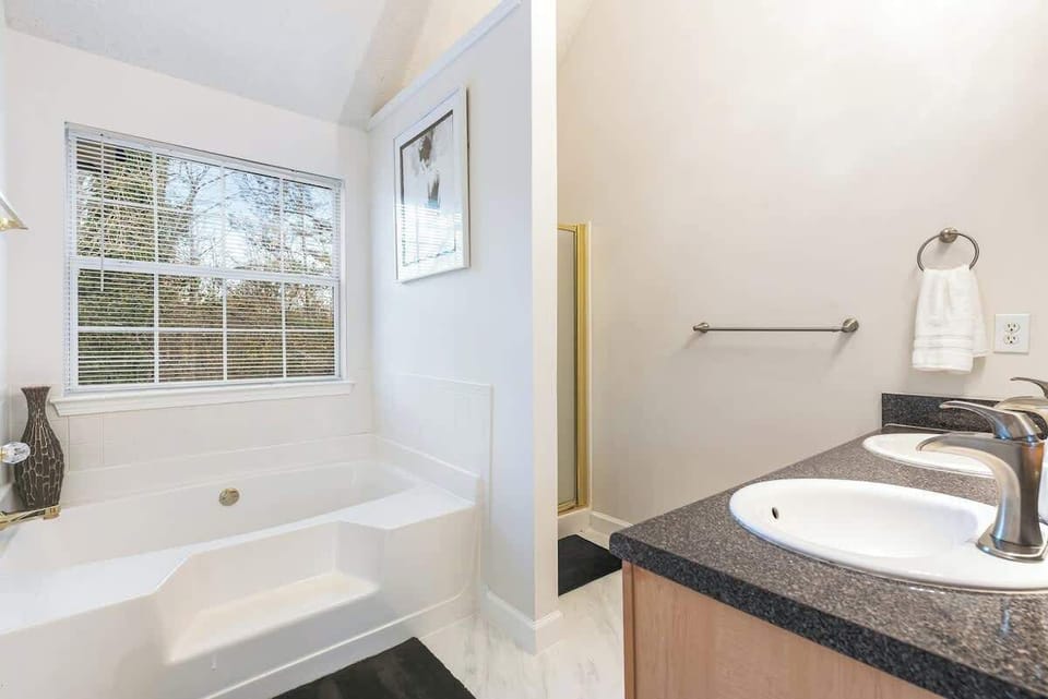 Master bathroom with soaking tub, standing shower and double vanity