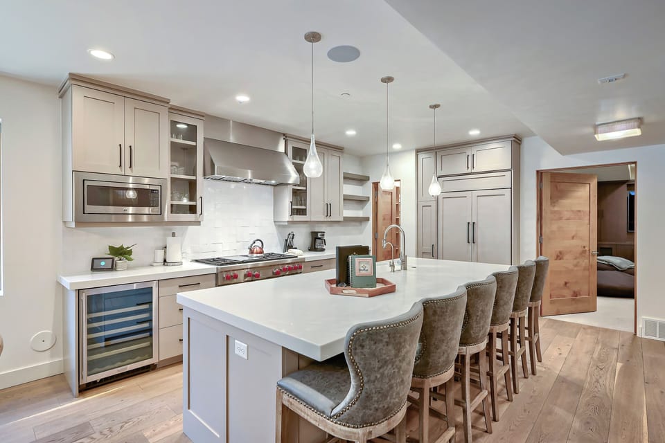 Your home away from home features a stunning chef's kitchen with a spacious island, perfect for gathering and preparing meals together during your stay.