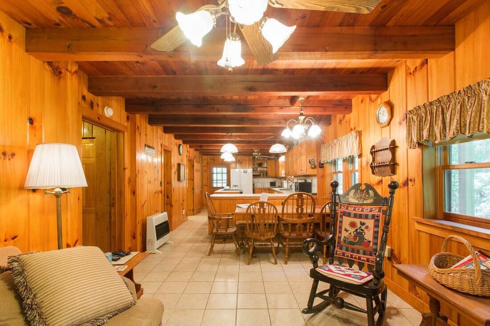 Large kitchen, dining area, and family room with a TV.