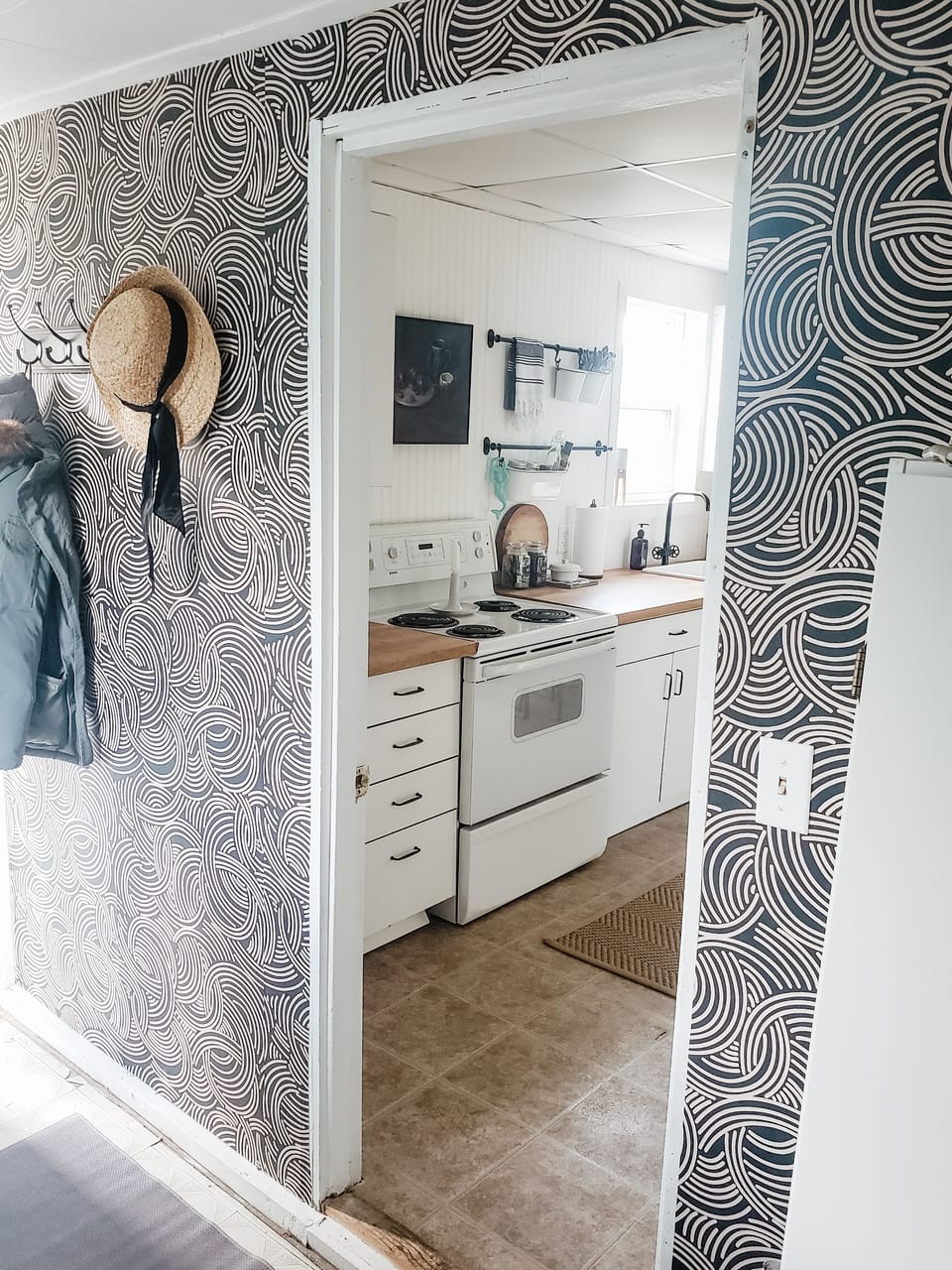 Full mud room with washer, dryer and supplies.