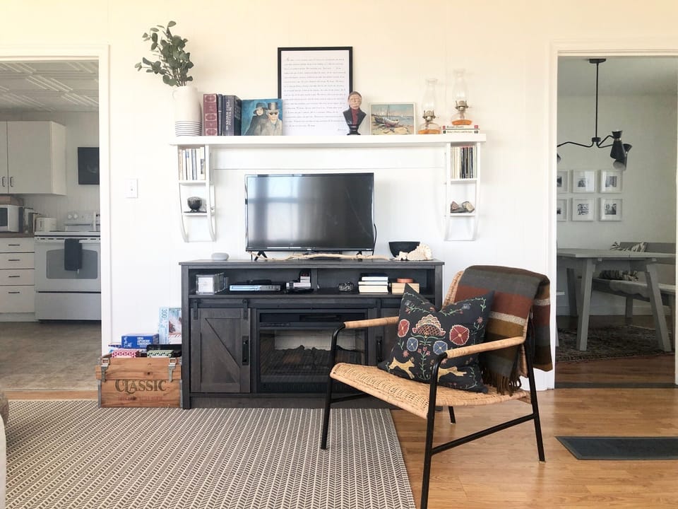 living room with fireplace, board games, books, TV, Netflix, DVDs & game console