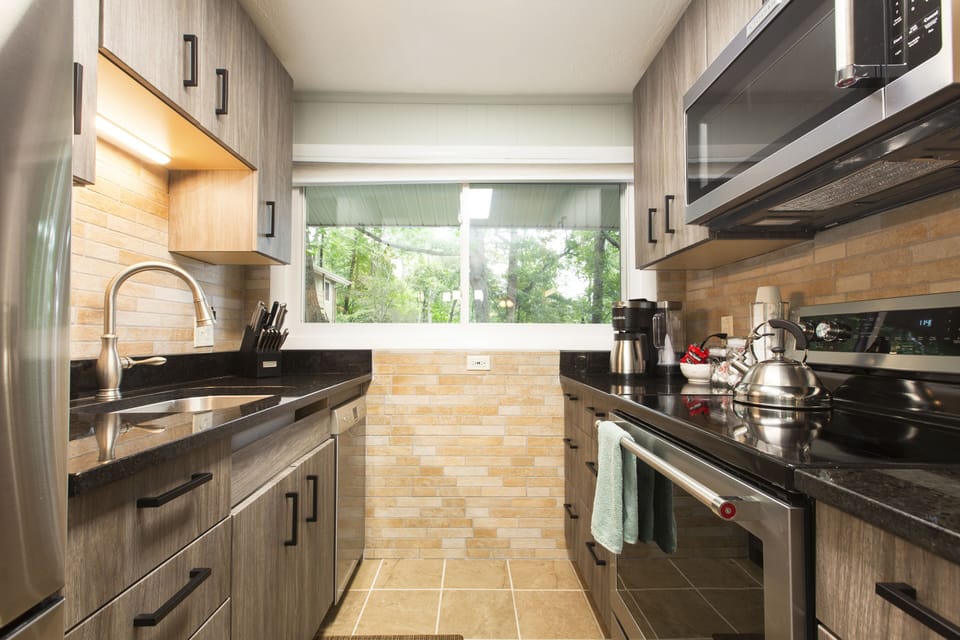 A snazzy galley kitchen with all modern appliances.