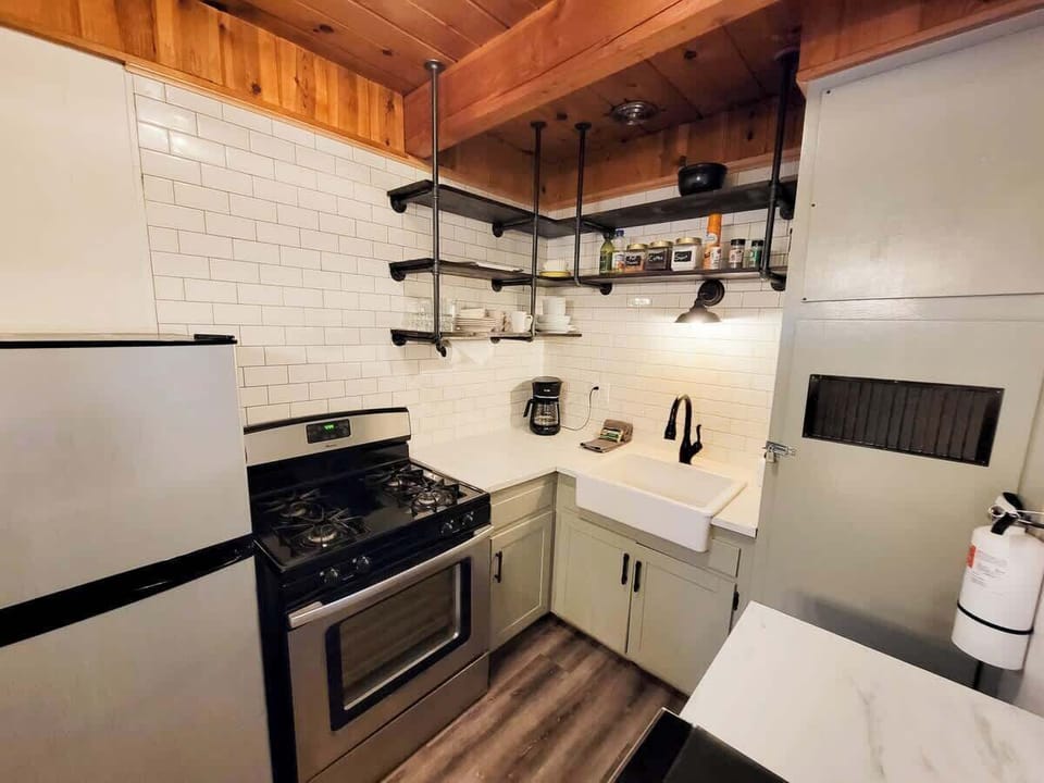 Kitchen- fully stocked bakeware and utensils. Gas stove, apartment sized fridge, microwave, and drip coffee maker.