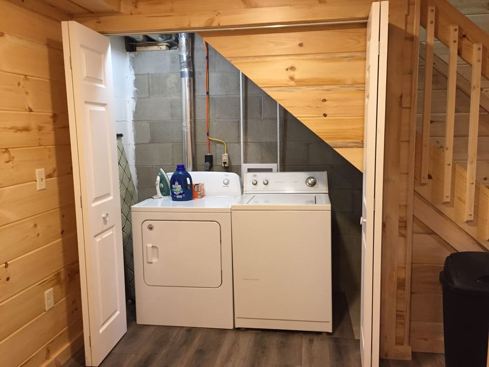Washer and dryer are located under the stairs.