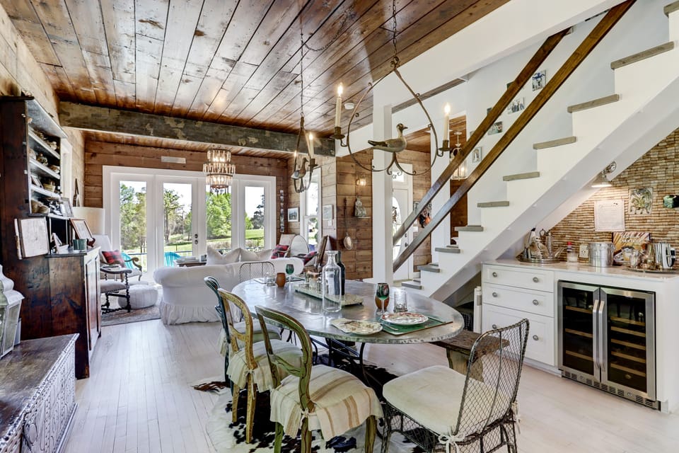 Zinc dining table for gathering
Bar under stairs with cooler