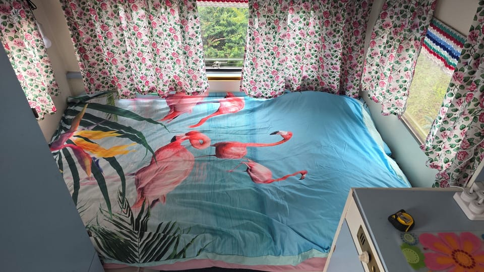 Cozy, colorful bedroom nook with garden views and playful tropical style