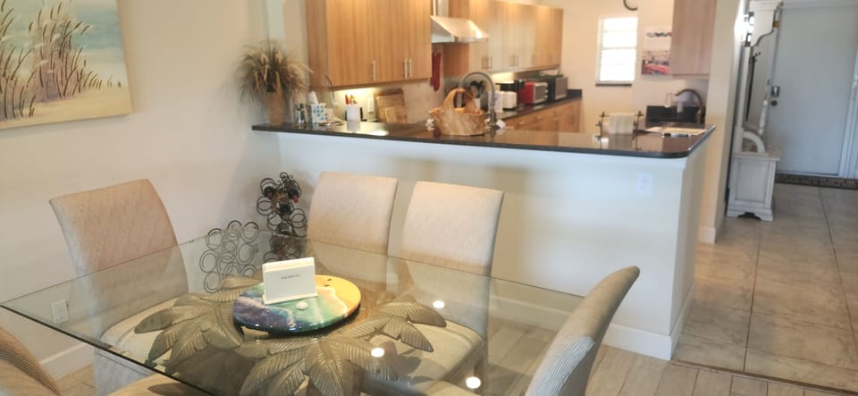 Enjoy a casual meal at our one of a kind,  palm tree pedestal, glass table
