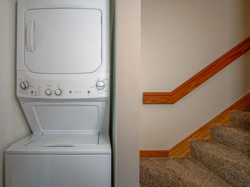 The washer and dryer are located to the left in the kitchen.