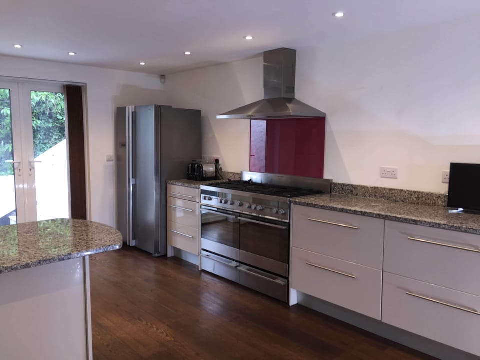 Kitchen with range oven, USA style fridge freezer, microwave & dishwasher
