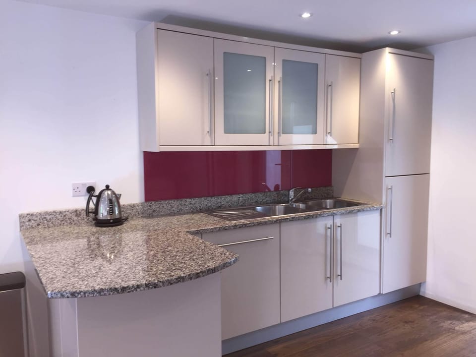 Kitchen with range oven, USA style fridge freezer, microwave & dishwasher