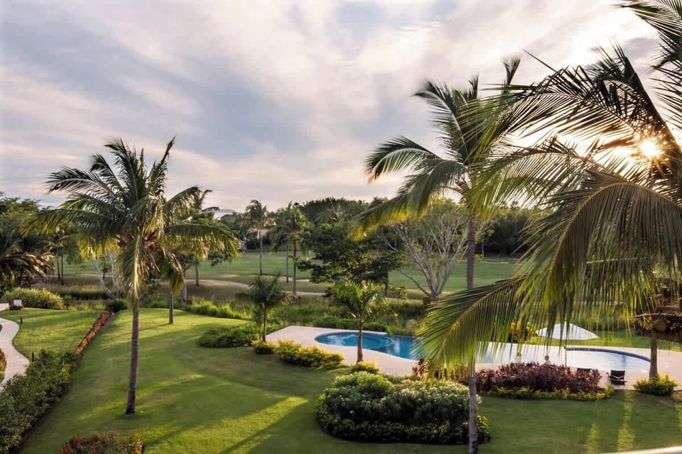 Spacious pool and garden area with sun loungers