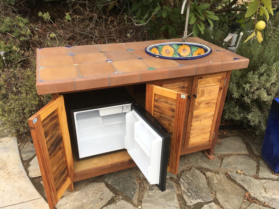 Cabinet, sink, and mini fridge