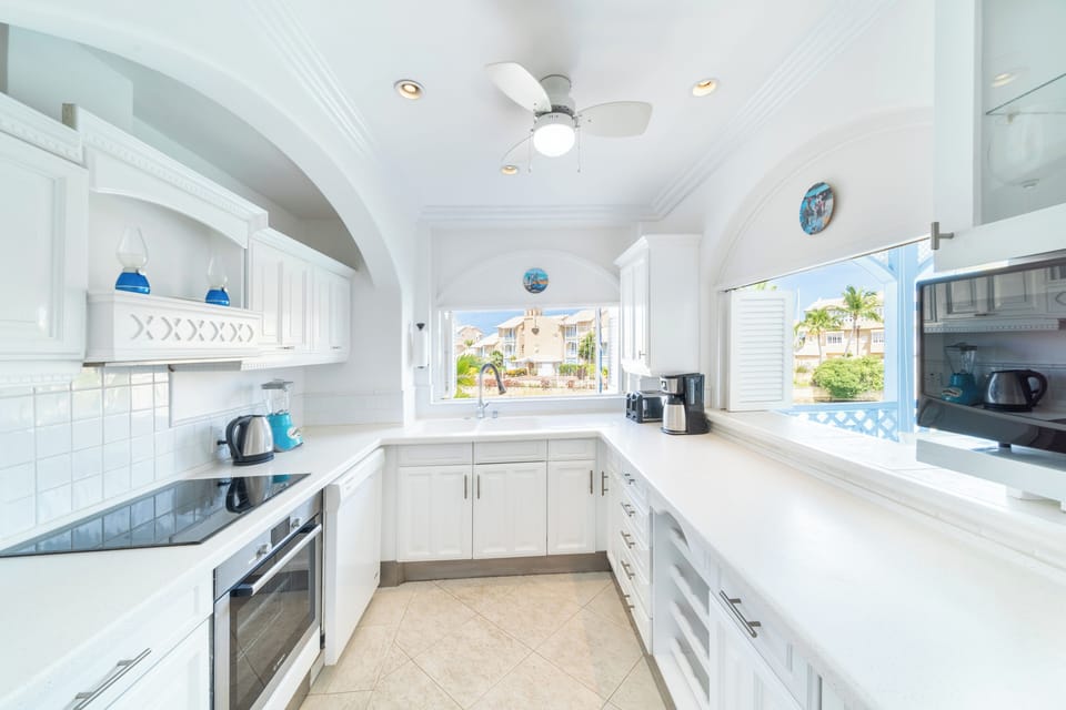 Fully equipped kitchen with view of lagoon and a pass through hatch