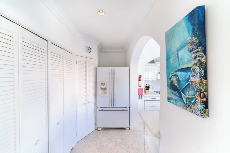 Entry to kitchen.  Laundry equipment screened by louvred doors.