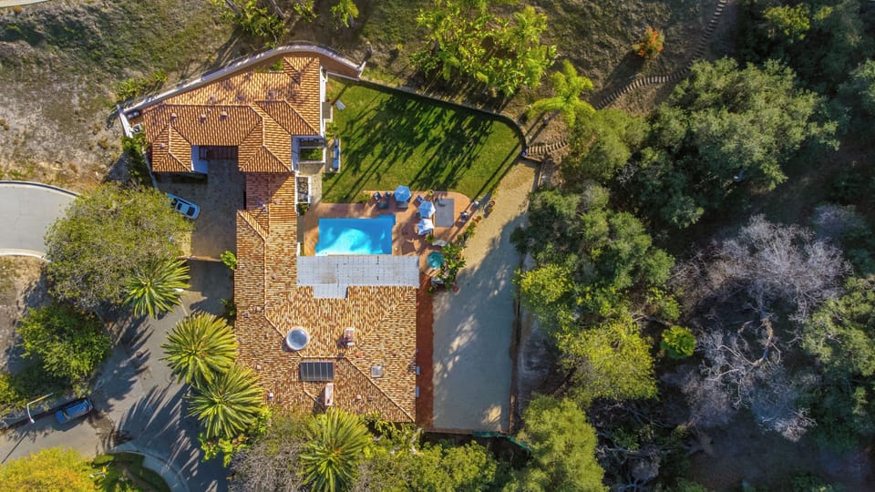 Ariel View of Property back yard with sand volleyball, large grassy area 