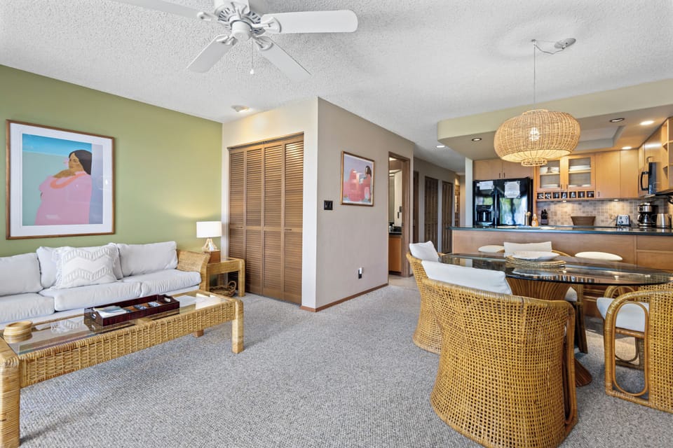 Unwind in your bright, open-concept space where natural textures meet comfort. Relax on the sofa, gather for meals at the dining table, and cook with ease in your fully equipped kitchen—all under a breezy ceiling fan.