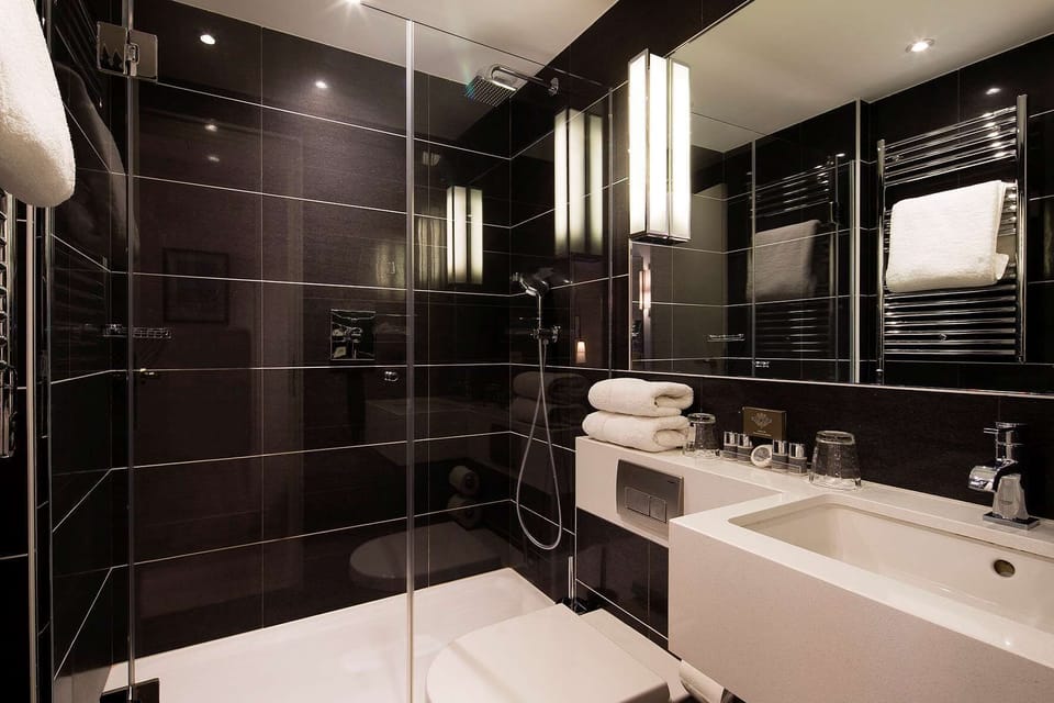 Combined shower/tub, designer toiletries, hair dryer, slippers