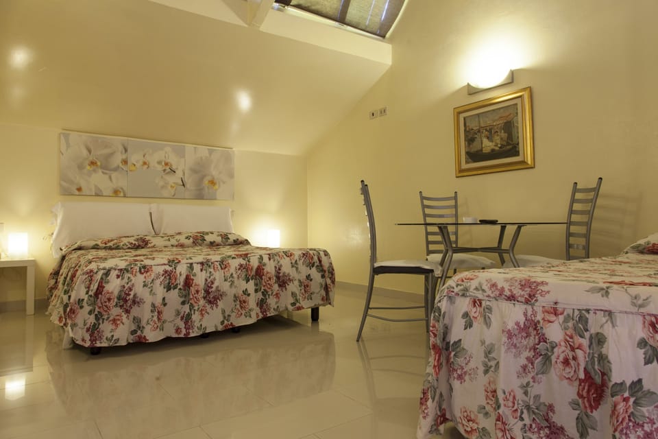 Triple Room | Down comforters, in-room safe, desk, blackout drapes