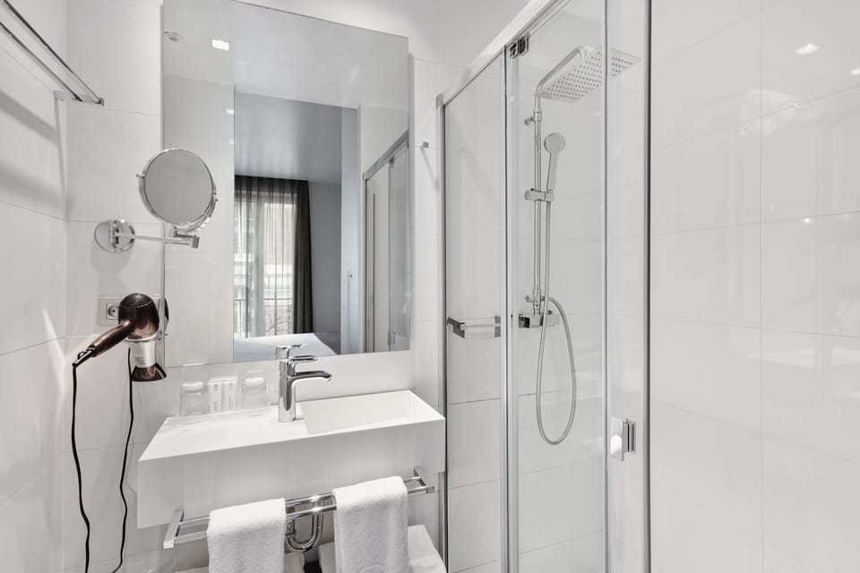 Shower, designer toiletries, hair dryer, towels