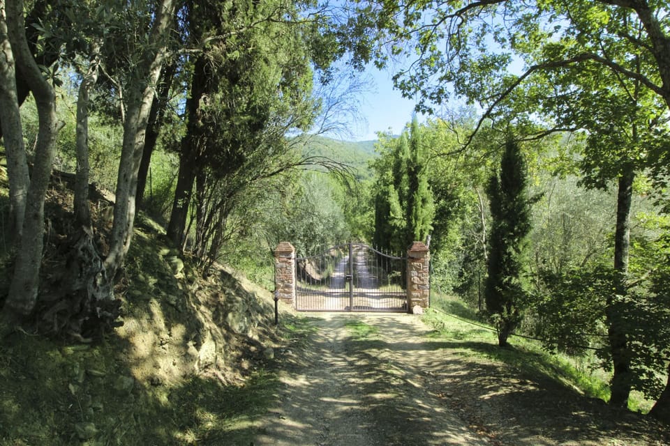 Ancient stone hamlet in an extremely panoramic position overlooking the wooded Val di Chio. Private Villa in Tuscany