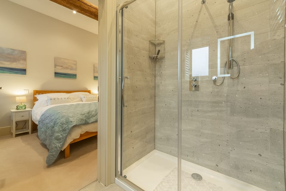 Ground floor: Bedroom two with double bed, en-suite with shower, wash basin and heated towel rail