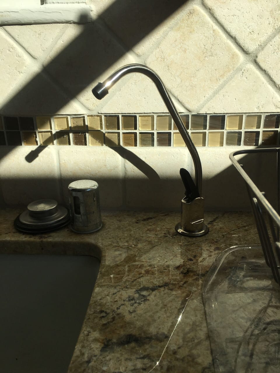 Filtered drinking water with compact carbon filter on tap.