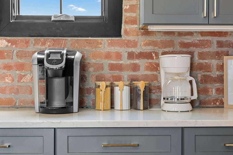 Bright, open-concept chef's kitchen located on second floor featuring stainless steel appliances, a spacious island with seating for five, and everything you need to prepare and enjoy meals together.
