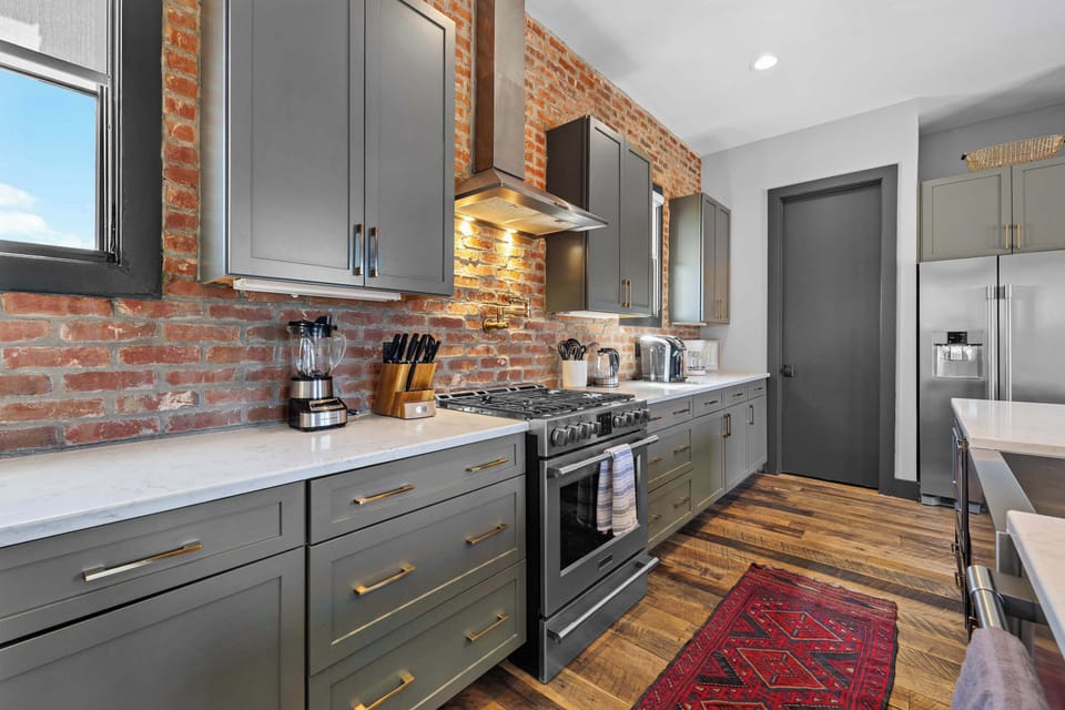 Bright, open-concept chef's kitchen located on second floor featuring stainless steel appliances, a spacious island with seating for five, and everything you need to prepare and enjoy meals together.
