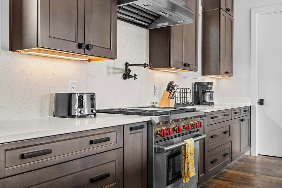 


Modern, fully equipped kitchen featuring stainless steel appliances, a large island with bar seating, ample counter space, and an open-concept layout perfect for cooking and gathering together.
