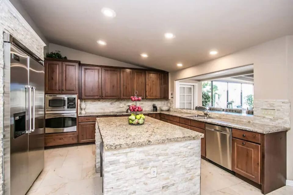 Kitchen fully stocked with pots, pans, dishes and appliances