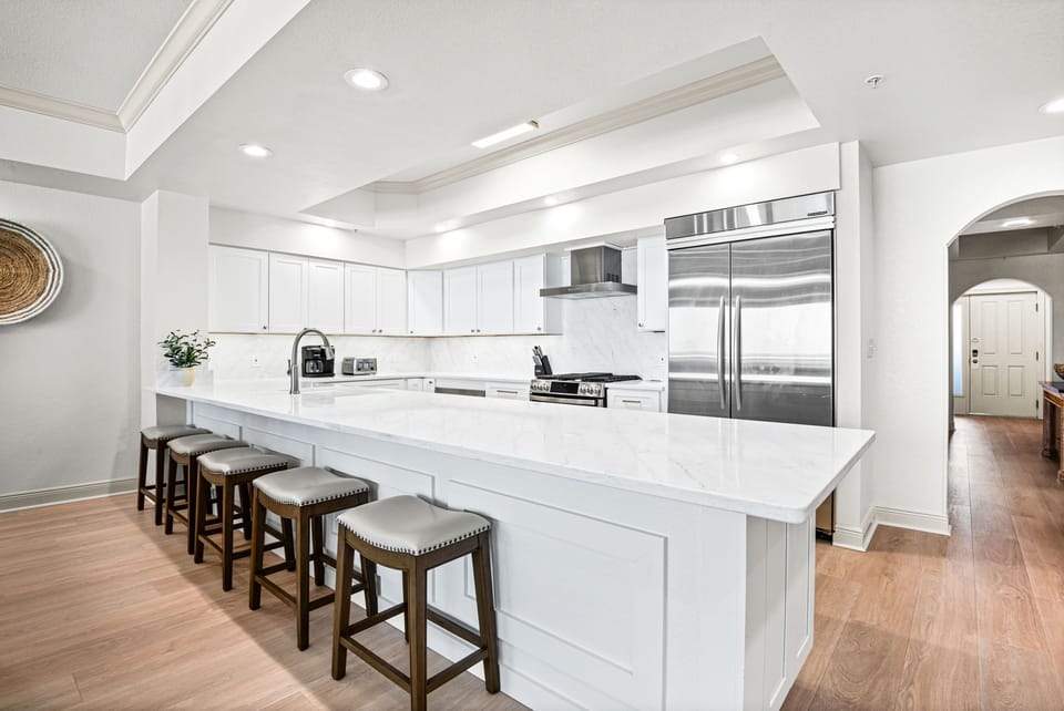 Chef's kitchen with quartz countertops, and professional-grade stainless appliances. The spacious island with bar seating invites gatherings and conversation.