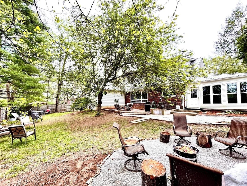 Backyard, Fire Pit, stone patio with Grill, seating around entire yard