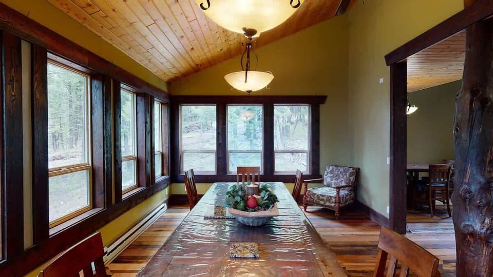 Large dining table that is located next to the kitchen.