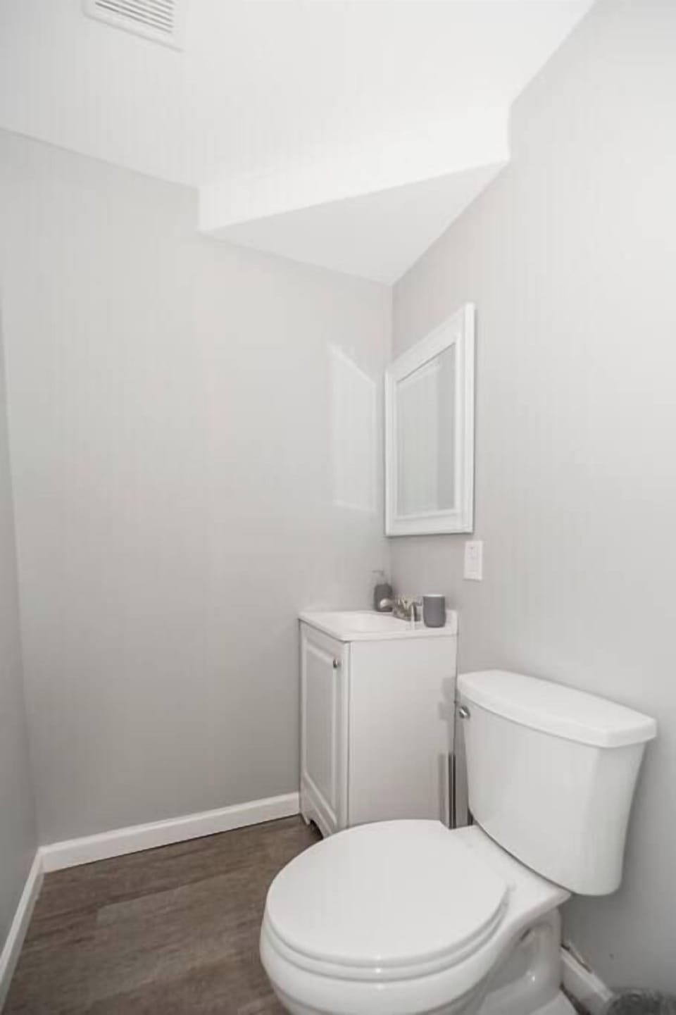 Use
this compact
basement half
bath for quick
trips between
ping-pong
rounds — it's
windowless
and cozy, best
suited for
guests already
downstairs
rather than a
primary
bathroom stop.
